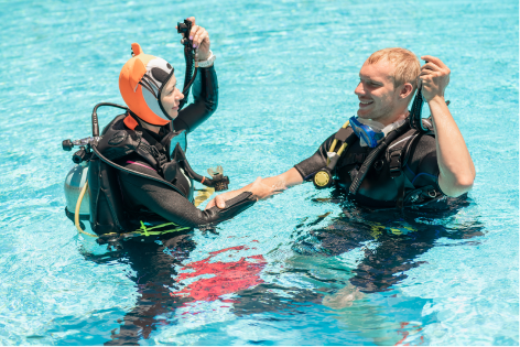 The Instructor and a diver practice in the pool